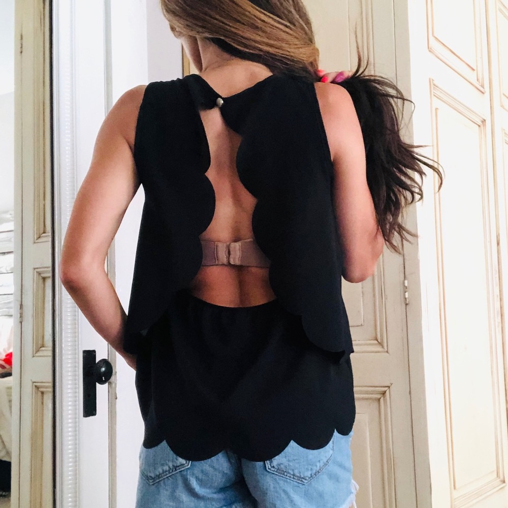 Scalloped layered black flowy top.